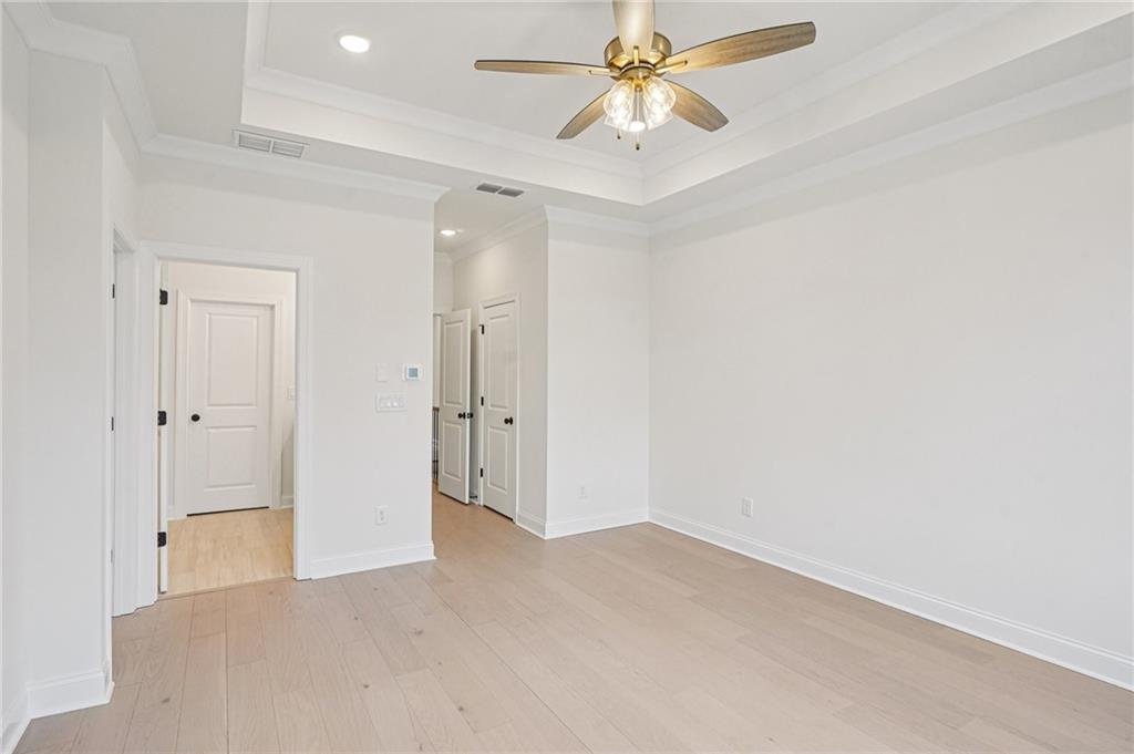 1502 Westend Way, Unit 331 Cumming, GA 30041 - Photo 14 of 38 an empty room with a chandelier fan and closet area