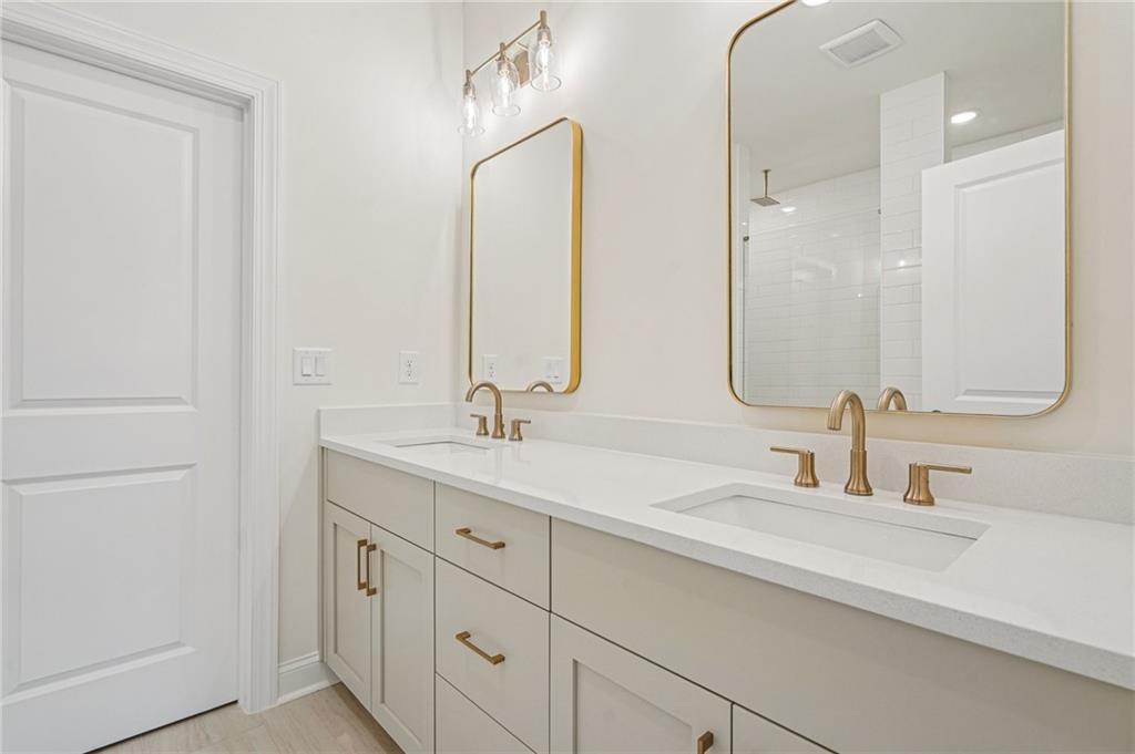 1502 Westend Way, Unit 331 Cumming, GA 30041 - Photo 15 of 38 a bathroom with double vanity sinks and a mirror