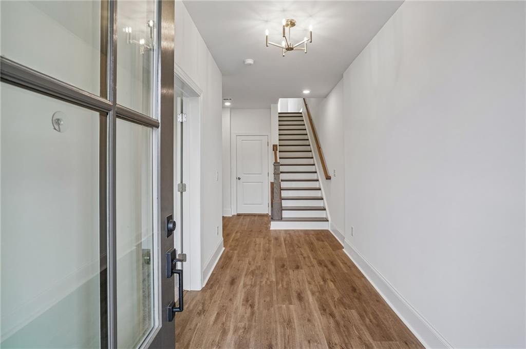 1502 Westend Way, Unit 331 Cumming, GA 30041 - Photo 2 of 38 a view of a hallway with wooden floor and staircase