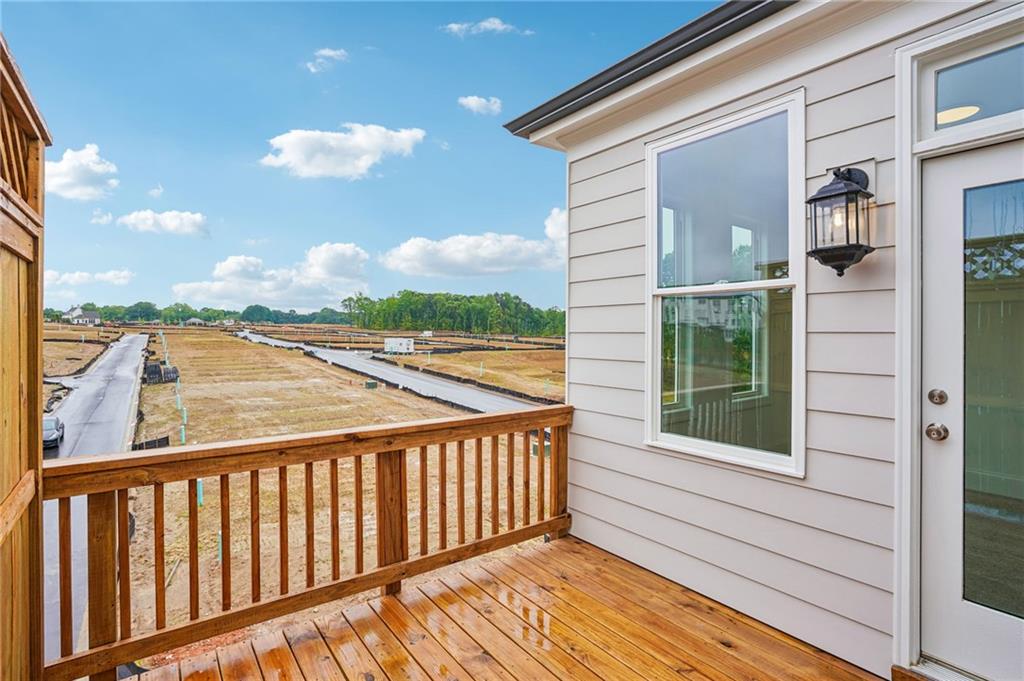 1502 Westend Way, Unit 331 Cumming, GA 30041 - Photo 23 of 38 a view of a balcony with wooden floor and fence