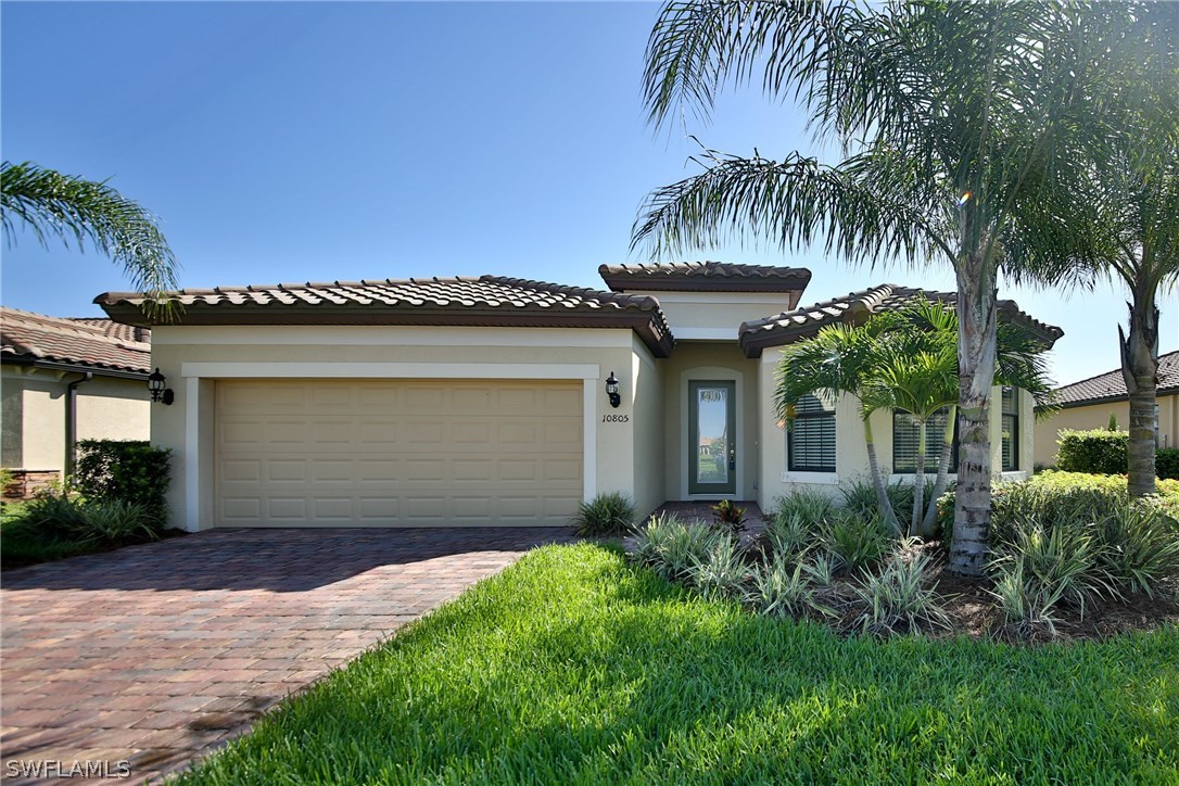a front view of a house with a yard and garage