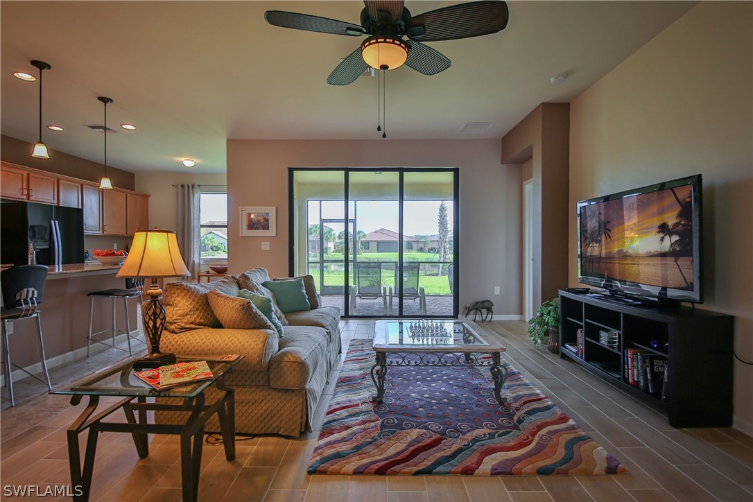 10805 Rutherford Road Fort Myers, FL 33913 - Photo 3 of 25 a living room with furniture and a flat screen tv