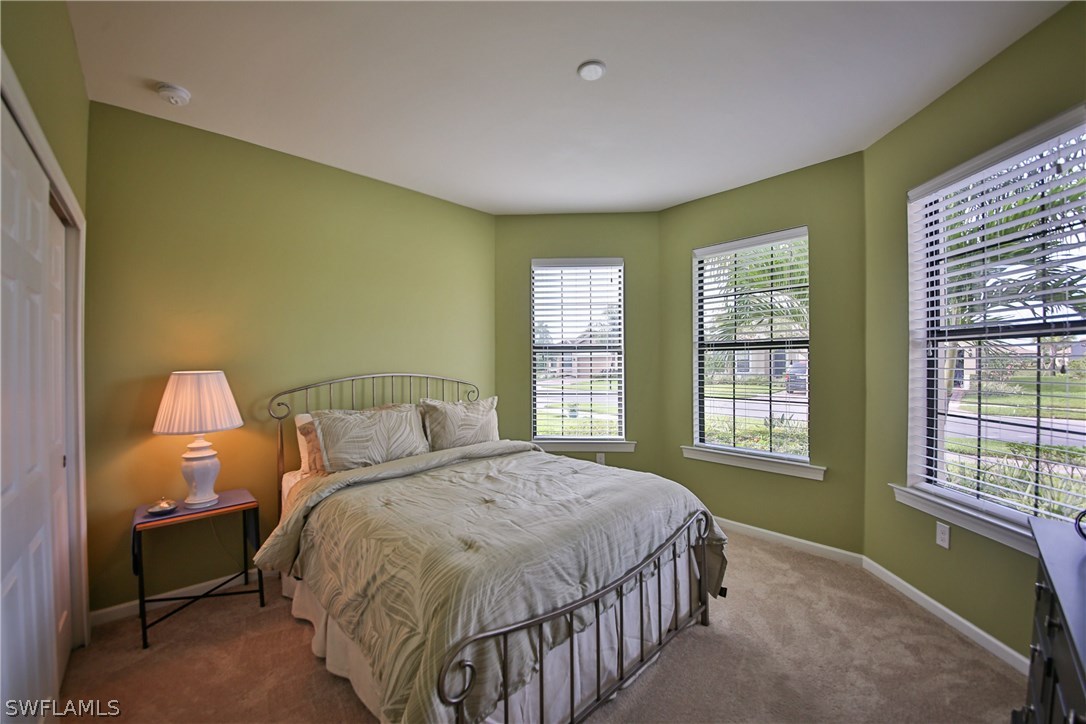 10805 Rutherford Road Fort Myers, FL 33913 - Photo 10 of 25 a bed sitting in a spacious bedroom next to a window
