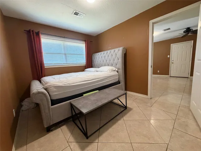 a bedroom with a bed and a dresser