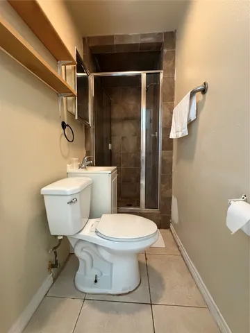 a white toilet sitting next to a bathroom sink