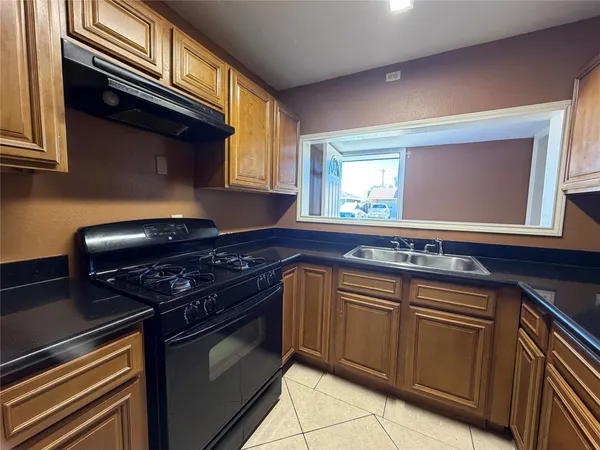 a kitchen with stainless steel appliances granite countertop a refrigerator and cabinets