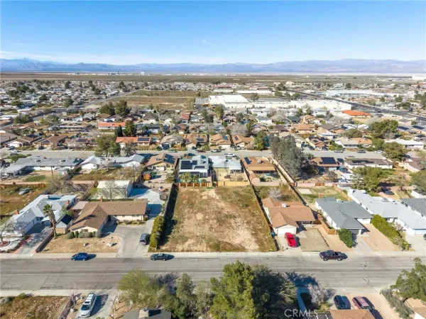 an aerial view of residential houses with city view
