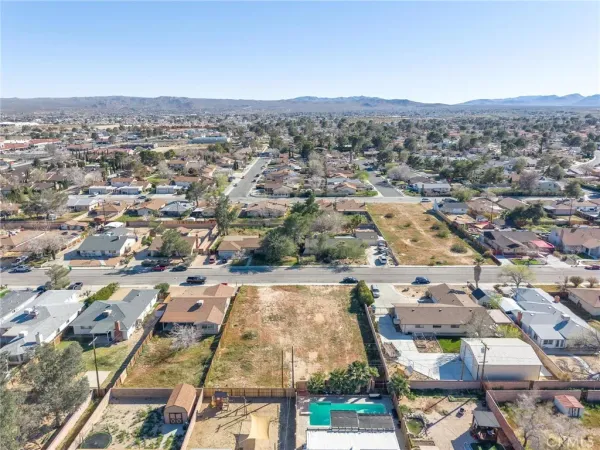 an aerial view of residential houses with city view