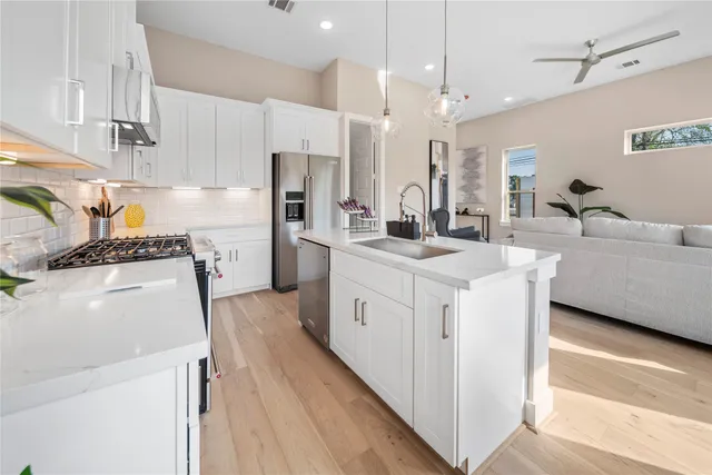 a kitchen with kitchen island white cabinets and white appliances