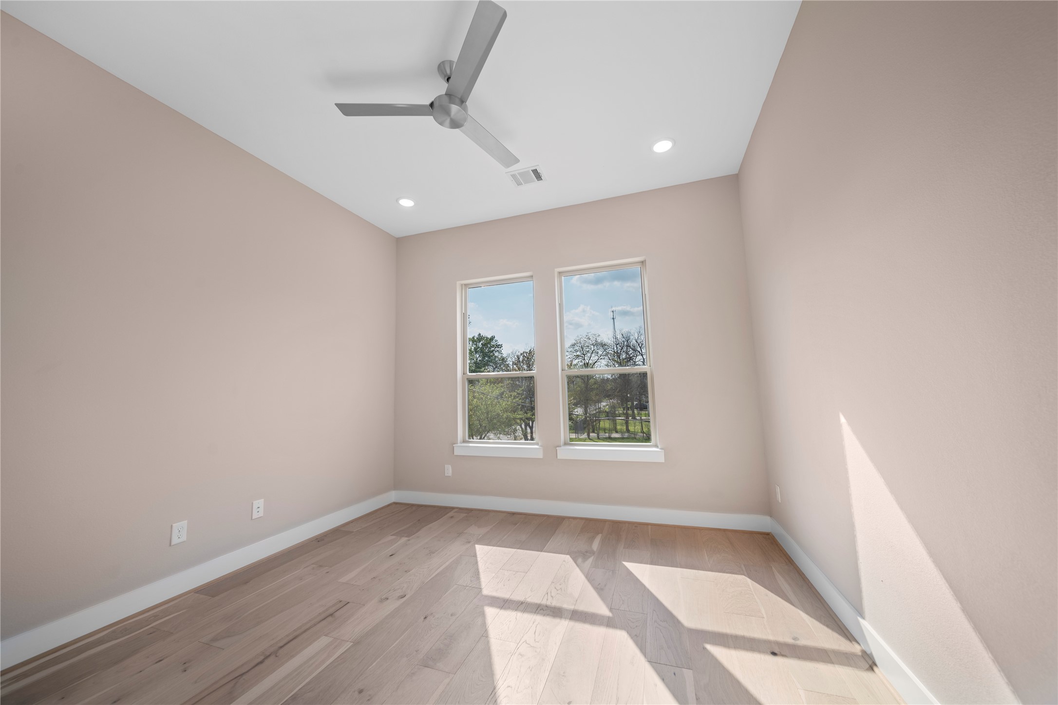 305 Chobani Lane Houston, TX 77091 - Photo 6 of 13 an empty room with a window and wooden floor
