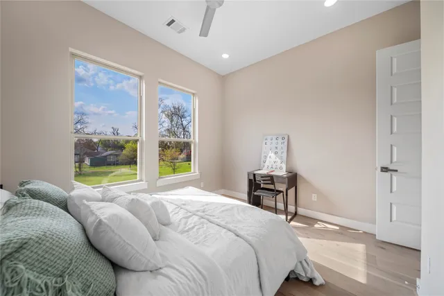 a bedroom with a bed and wooden floor