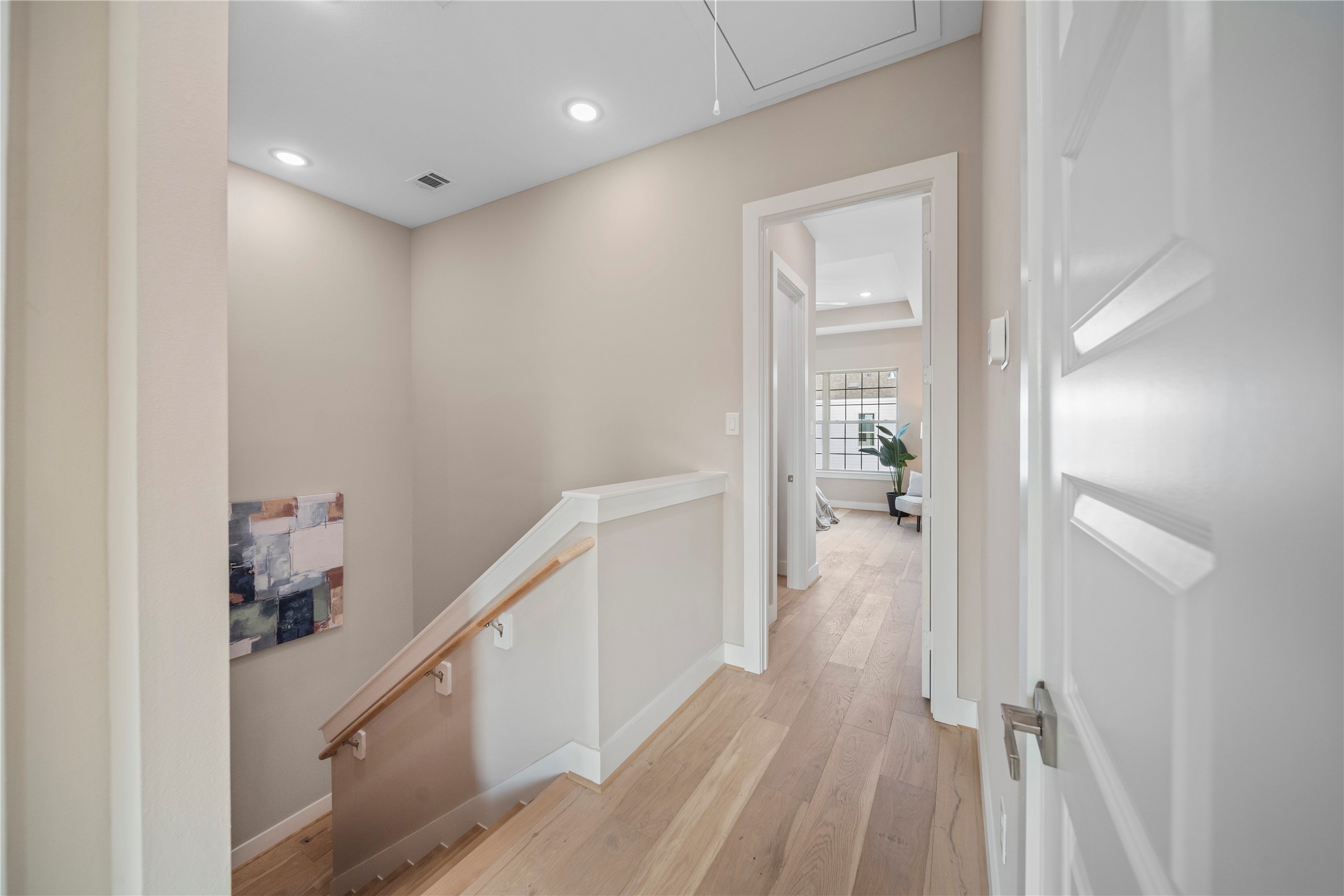 305 Chobani Lane Houston, TX 77091 - Photo 8 of 13 a view of a hallway with wooden floor and staircase