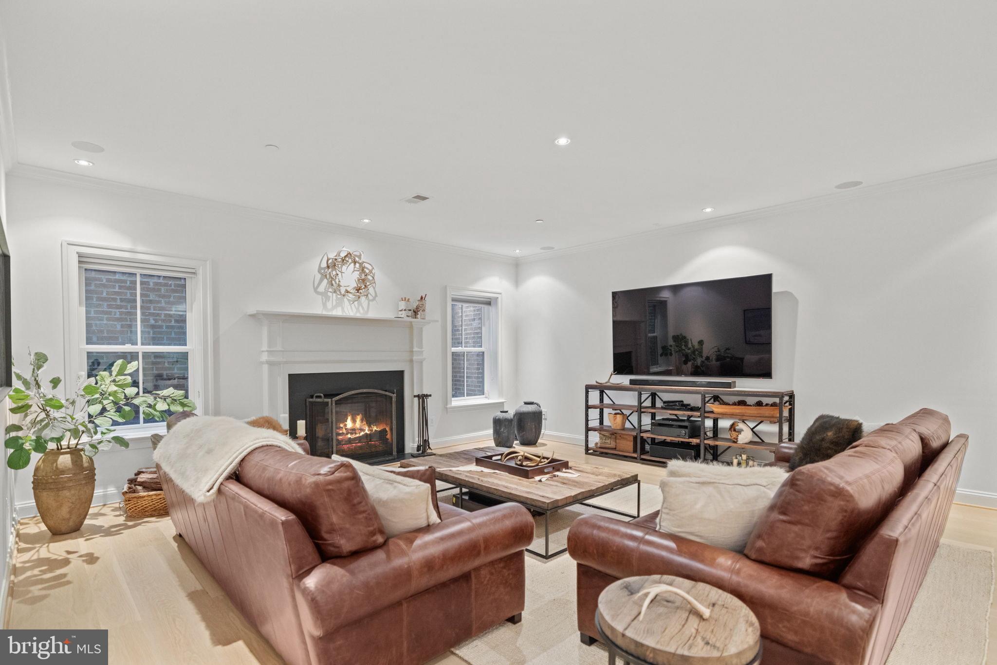 4410 Meadow Road Washington, DC 20007 - Photo 24 of 30 a living room with furniture a flat screen tv and a fireplace