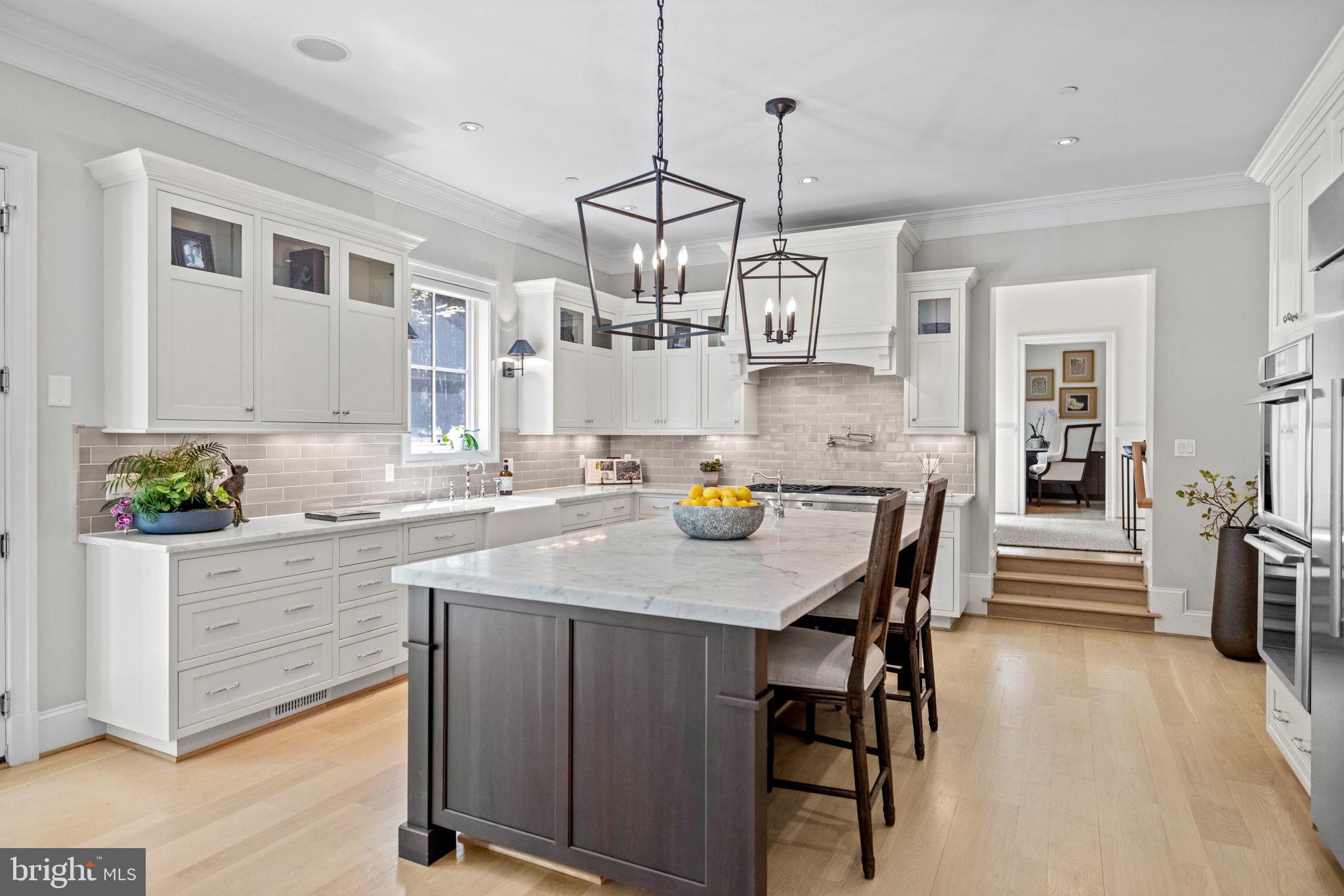 4410 Meadow Road Washington, DC 20007 - Photo 3 of 30 a kitchen with a table and chairs in it