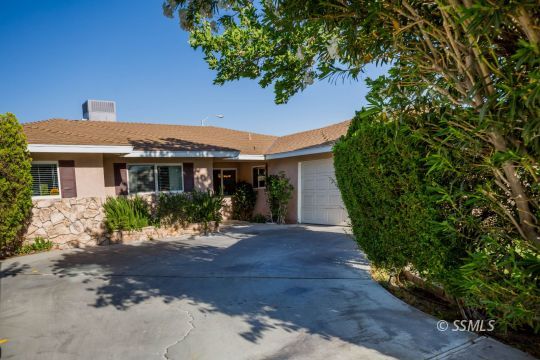 500 Scott Street Ridgecrest, CA 93555 - Photo 1 of 37 a front view of a house with a yard and potted plants