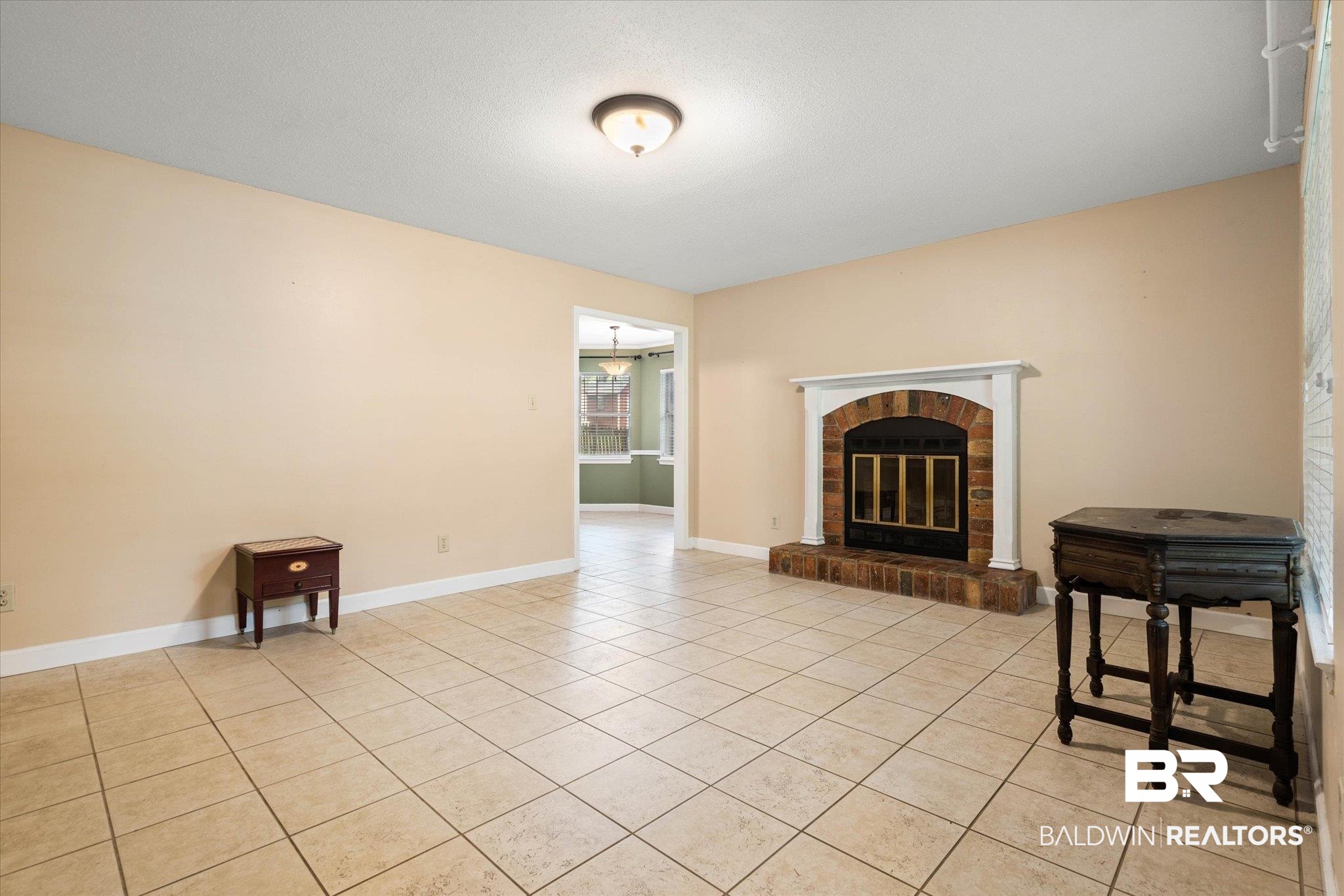 6632 Autumn Ridge Drive Mobile, AL 36695 - Photo 4 of 22 Unfurnished living room featuring light tile patterned floors and a fireplace
