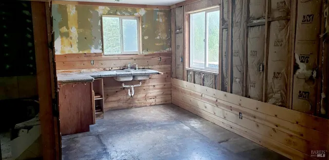 a bathroom with a double vanity sink a mirror and a bathtub