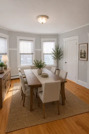a view of a dining room with furniture and wooden floor