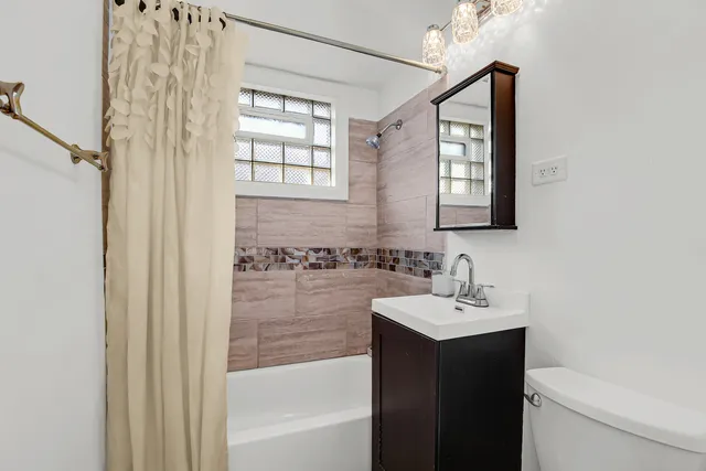 a bathroom with a sink a mirror and a bathtub