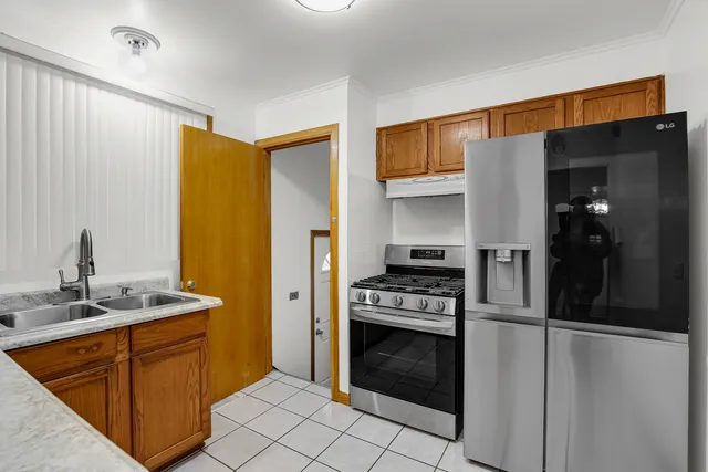 a kitchen with stainless steel appliances granite countertop a refrigerator and a sink