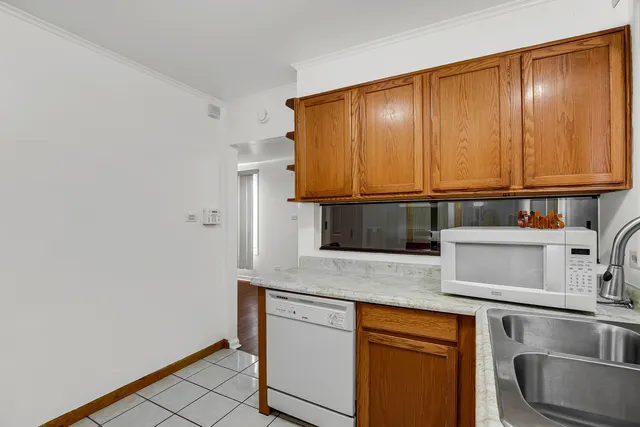 a kitchen with stainless steel appliances granite countertop a sink and a microwave
