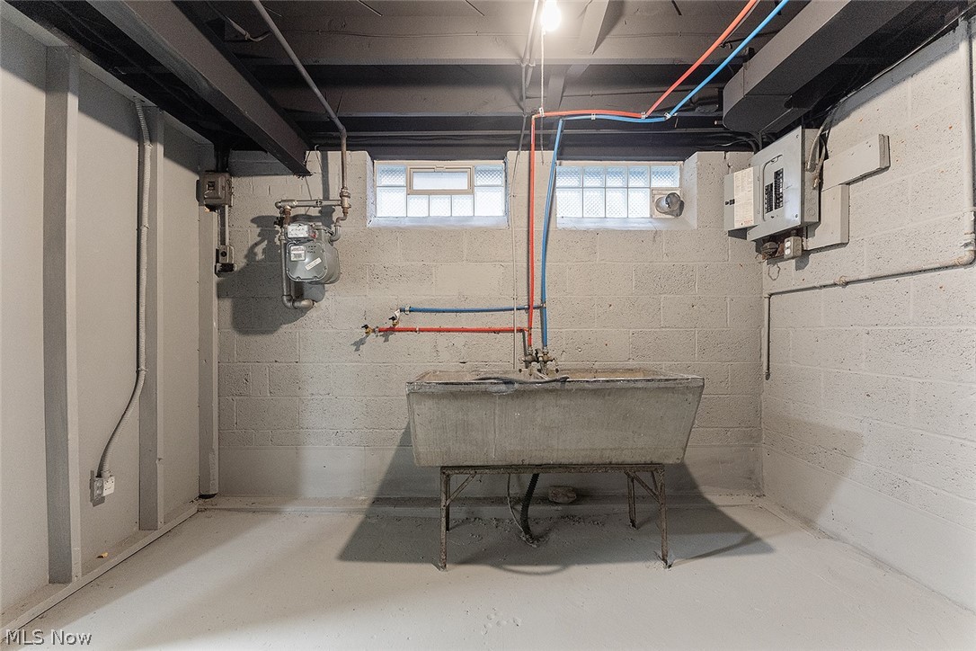 3791 Fairoaks Road South Euclid, OH 44121 - Photo 26 of 30 Basement utility area featuring a concrete wash tub, exposed ceiling joists, and block glass windows