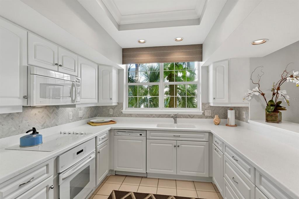 729 South Harbor Drive, Unit 1 Boca Grande, FL 33921 - Photo 14 of 68 a kitchen with a sink stove and cabinets