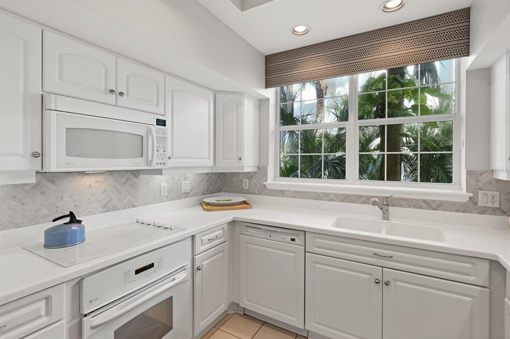 729 South Harbor Drive, Unit 1 Boca Grande, FL 33921 - Photo 16 of 68 a kitchen with a sink cabinets and window