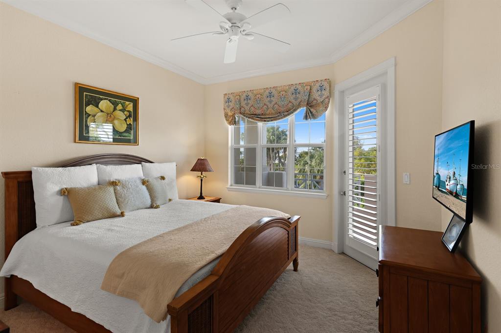 729 South Harbor Drive, Unit 1 Boca Grande, FL 33921 - Photo 17 of 68 a bedroom with a bed and a flat screen tv