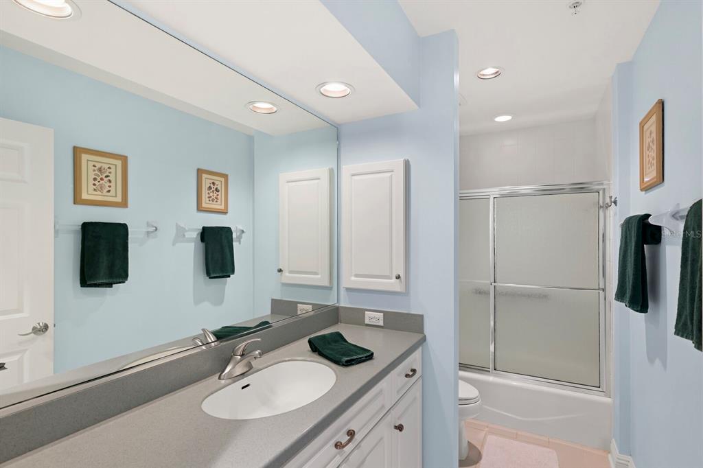 729 South Harbor Drive, Unit 1 Boca Grande, FL 33921 - Photo 17 of 68 a bathroom with a granite countertop sink and a mirror