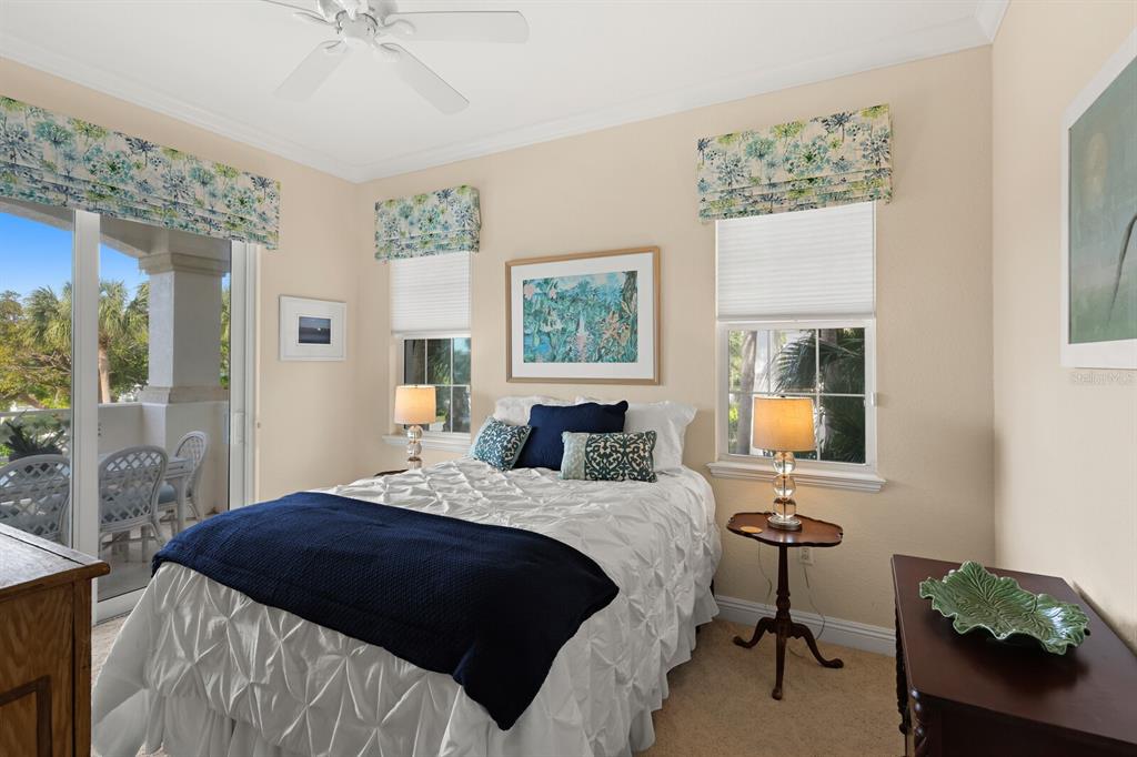 729 South Harbor Drive, Unit 1 Boca Grande, FL 33921 - Photo 19 of 68 a bedroom with a bed window and table