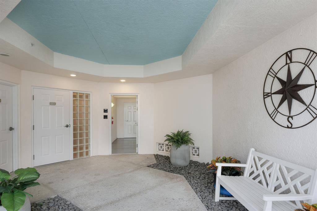 729 South Harbor Drive, Unit 1 Boca Grande, FL 33921 - Photo 22 of 68 a spacious bedroom with a potted plant on the table and chair