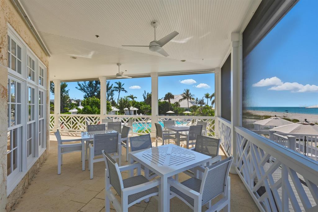 729 South Harbor Drive, Unit 1 Boca Grande, FL 33921 - Photo 30 of 68 a dining room with furniture a rug and a floor to ceiling window
