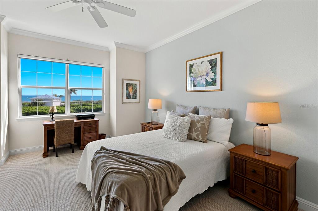 729 South Harbor Drive, Unit 1 Boca Grande, FL 33921 - Photo 8 of 68 a bedroom with a bed and a lamp on table