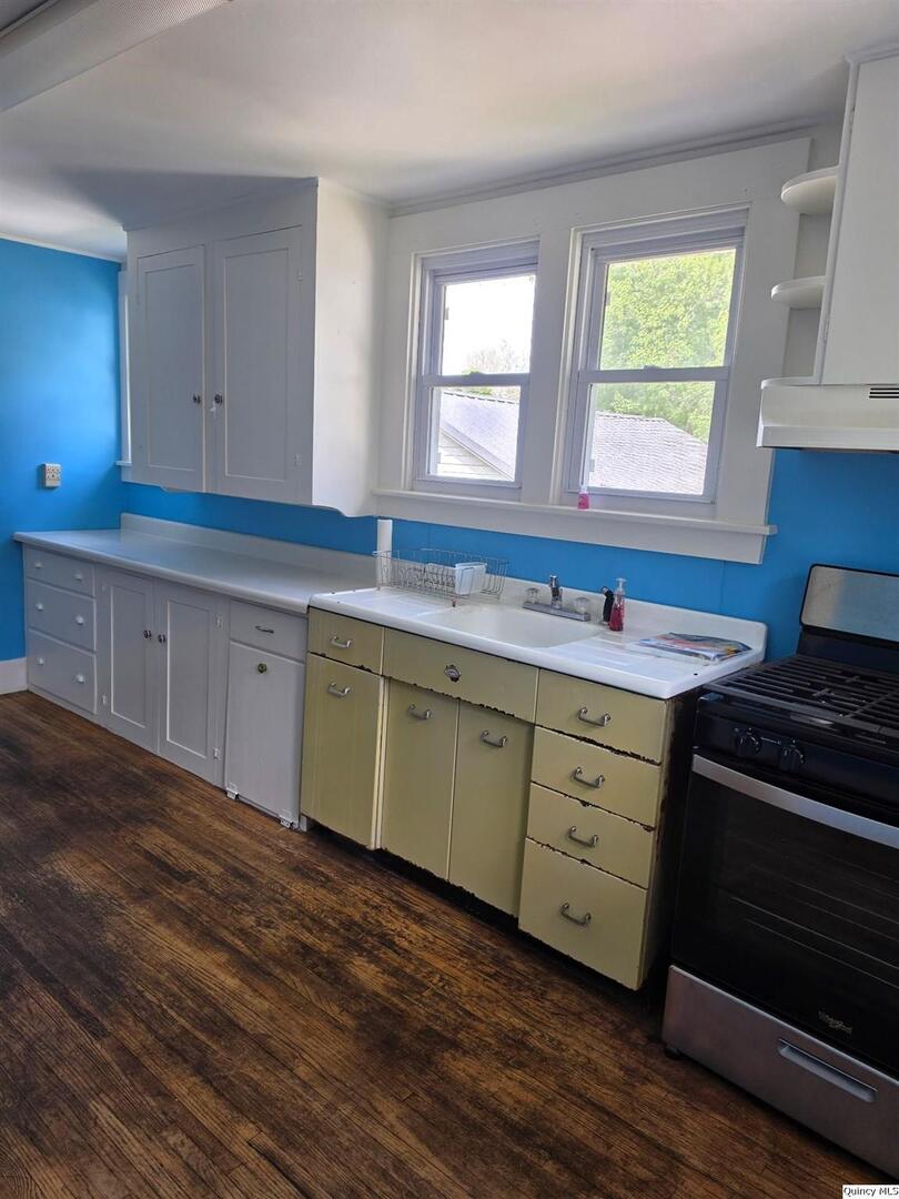 304 West 3rd Street Golden, IL 62339 - Photo 7 of 18 a kitchen with sink cabinets and window