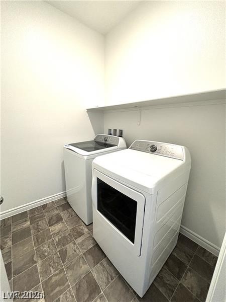 8336 Rowan Rdg Avenue Las Vegas, NV 89147 - Photo 13 of 15 This practical laundry room features functional appliances and a convenient storage shelf.
