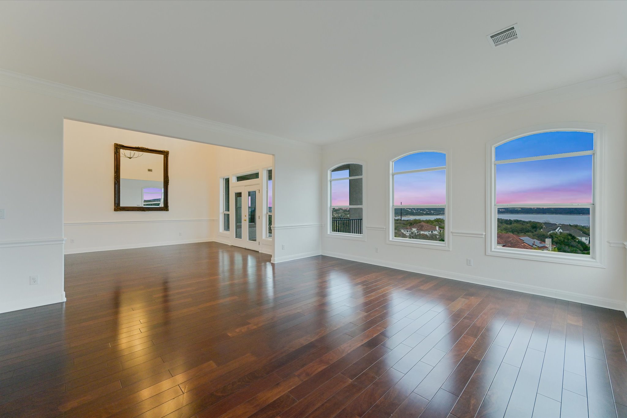 4319 Rum Runner Road Austin, TX 78734 - Photo 13 of 40 Empty room with dark wood-style flooring and ornamental molding