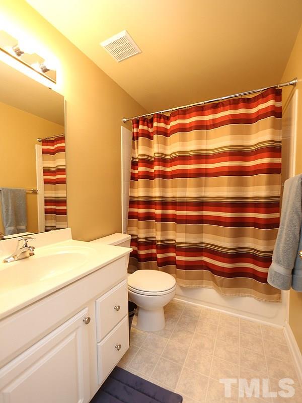 5317 Echo Ridge Road Raleigh, NC 27612 - Photo 15 of 17 a bathroom with a sink a toilet and a shower