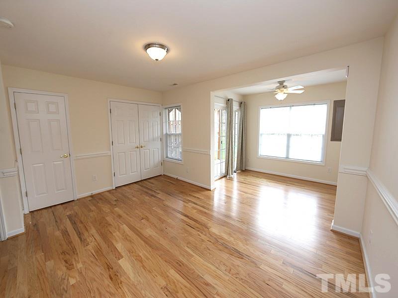 5317 Echo Ridge Road Raleigh, NC 27612 - Photo 16 of 17 an empty room with wooden floor and windows