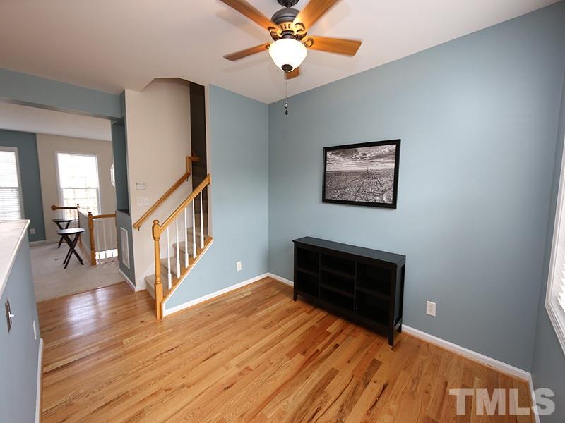 5317 Echo Ridge Road Raleigh, NC 27612 - Photo 5 of 17 a view of a livingroom with wooden floor and a ceiling fan