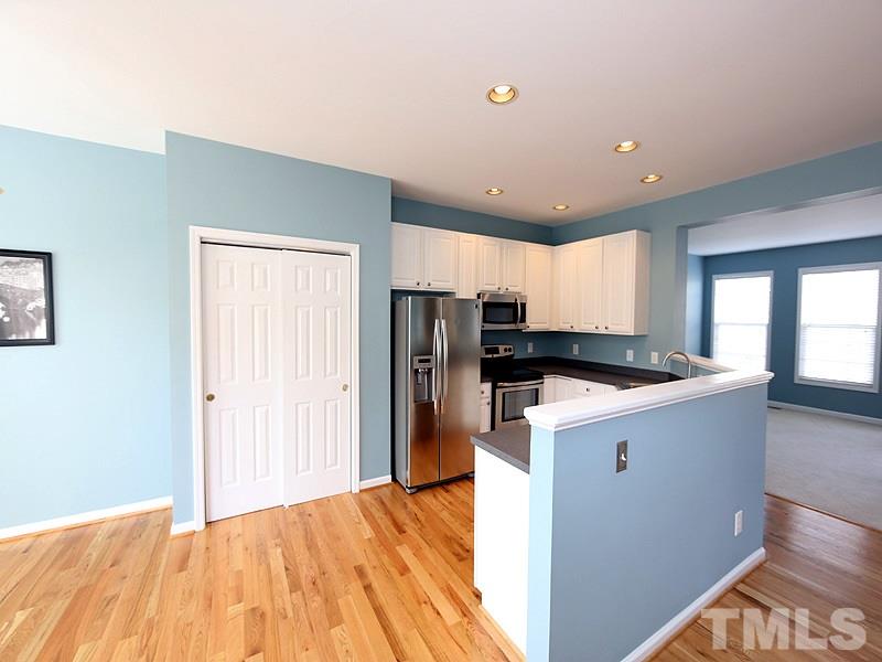 5317 Echo Ridge Road Raleigh, NC 27612 - Photo 6 of 17 a kitchen with refrigerator and cabinets