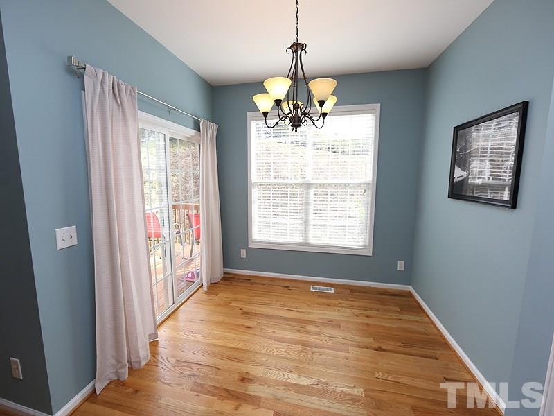 5317 Echo Ridge Road Raleigh, NC 27612 - Photo 8 of 17 a view of an empty room with wooden floor and a window