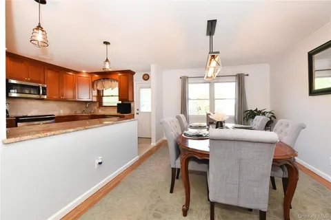 a kitchen with stainless steel appliances granite countertop sink microwave and white cabinets
