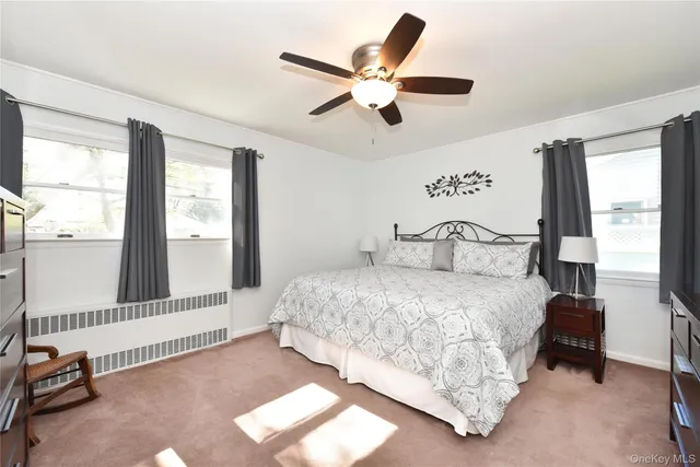 a bedroom with a bed and a large window with the outer view