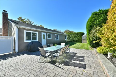 a view of a backyard with sitting area