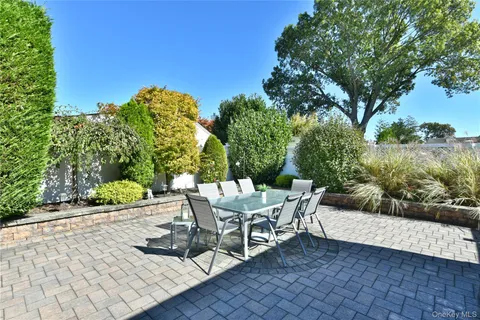 a view of a patio with table and chairs and potted plants