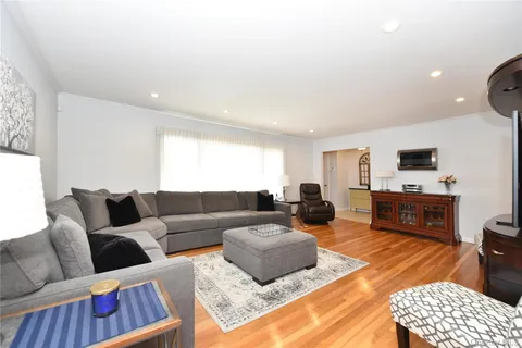 a living room with furniture a rug and a flat screen tv