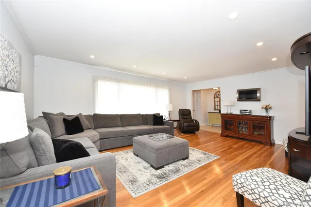 a living room with furniture a rug and a flat screen tv