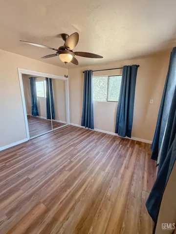 a view of a livingroom with a ceiling fan and window