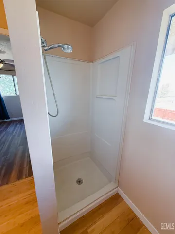 a bathroom with a glass shower door